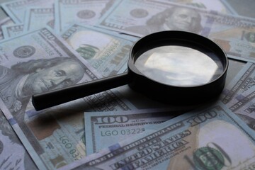 Money, United States dollar and magnifying glass. Business and financial concept