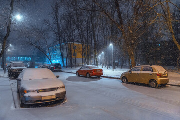 Heavy snowfall in Moscow. cars in the Parking lot near the houses in the snow. Residential areas of Moscow in a snowstorm.