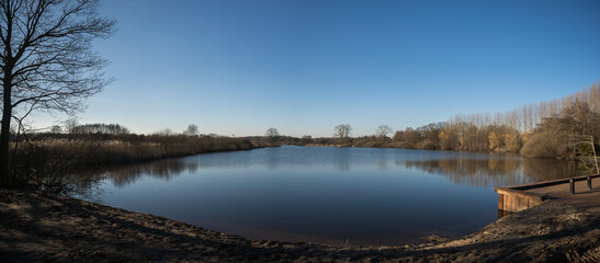 Panorama of lake 'Wijchense Ven', a natural reserve area in Wijchen, the Netherlands on a sunny day in February