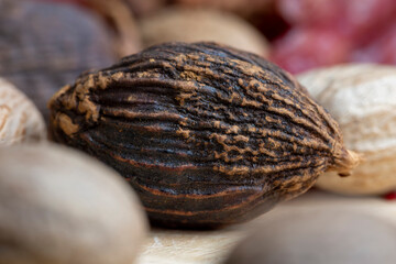 A whole nutmeg fruit on the kitchen table