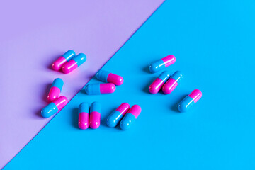 pink and blue pills on pink and blue background. Pregnancy conception. Girl or boy
