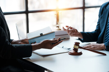 Lawyer and client sign variou financial legal contract to mediate with the legal execution...