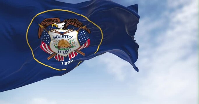 The Utah state flag fluttering in the wind on a sunny day