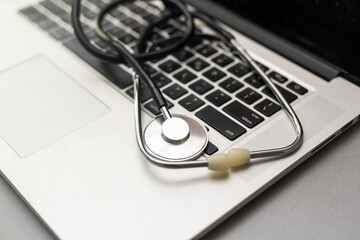 Stethoscope on the keyboard of laptop