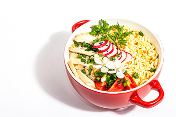 Asian noodles with chicken, vegetables, and herbs are isolated on a white background