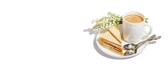 Cup of coffee and waffle cake isolated on a white background. Sweet dessert with lily valley bouquet