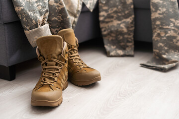 Set of military uniform on wooden background, close up view