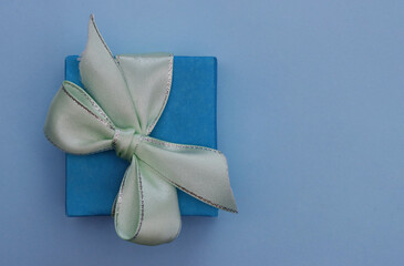 Wrapped vintage gift box with light green ribbon bow.