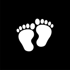 Baby feet icon on black background.