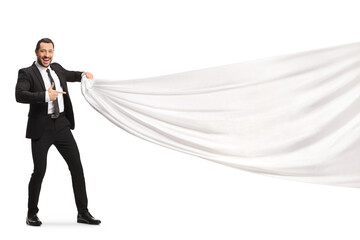 Businessman pulling a white piece of cloth and pointing - obrazy, fototapety, plakaty