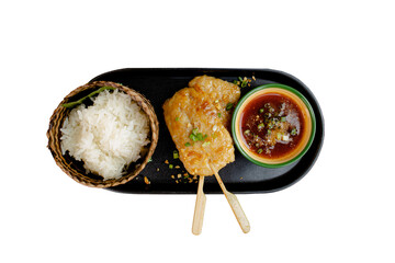 Savory Delights: A culinary presentation featuring grilled skewers of succulent meat, accompanied by a vibrant dipping sauce and a side of fluffy, aromatic rice.