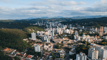 Fototapeta na wymiar aerial image of downtown Blumenau, with Itajaí Açú River, Santa Catarina, southern Brazil, buildings, main streets, vegetation and sunny day