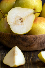 A yellow ripe pear with a red side on the table