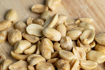 Roasted peanuts on a wooden cutting board