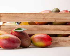 Fresh mangoes in wooden box
