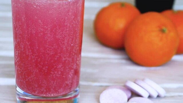 Throw a vitamin C into a glass of water. The concept of drinking vitamin c in tablets. Close-up fruit juice or freshly squeezed. Tablets against beriberi