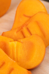 Sliced ripe orange pitted persimmon