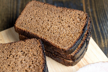Square loaf of black rye bread Cut into pieces