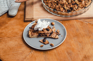 Sweet pie with apples and nuts on a blue plate