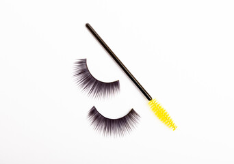 Mascara brushes, makeup brushes, applicators and false eyelashes isolated on white background. Close-up. Brushes for eyelash extensions.