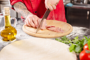 pizzaiolo prepares pizza in the kitchen, the chef prepares the dough