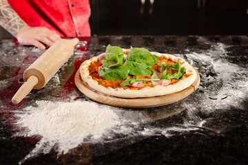 pizzaiolo prepares pizza in the kitchen, the chef prepares the dough