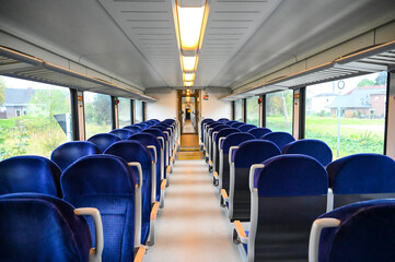 The interior of a modern passenger train. Traveling by railways. Interior of train wagon with...