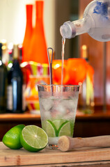 Caipiroska, Brazilian traditional drink: with vodka with blurred colored bottles in the background