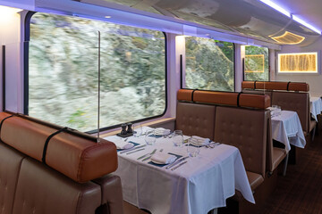 Interior of the gold leaf Rocky Mountaineer dining car train wagon while riding in British Columbia, Canada.