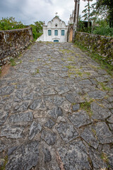 Stone path to antique construction in historical city of Itanhaem, coast of state of Sao Paulo, Brazil