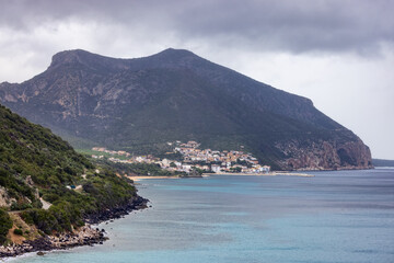 Coastline on a rocky shore near Cala Gonone, Sardinia. Cloudy Sunrise Sky.