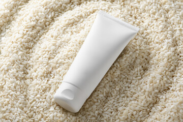 White squeeze bottle plastic tube mockup for medicine or cosmetics on white rice background. Skin care product body lotion, shampoo, face cream, gel or mask, Natural organic beauty cosmetics concept