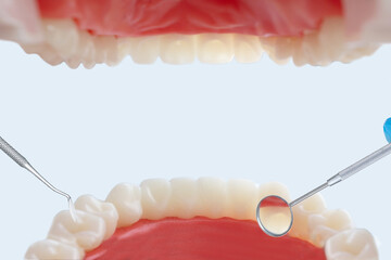 View from patient mouth with professional dental tools. Teeth care and protection concept. Closeup.
