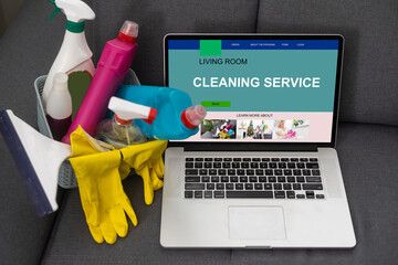 a basket with detergents, a laptop with a cleaning application