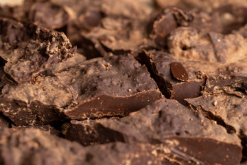 Pieces of chocolate with added cocoa and sugar