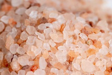 A large number of pink salt crystals of different sizes
