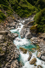 Fototapeta na wymiar The Haast river flowing through the Gates of Haast, a deep river gorge in the Mount aspiring National Park in the South Island of New Zealand