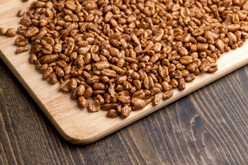 Grain wheat covered with a thin layer of chocolate