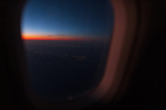 The plane flies at night. View from the window of the plane on the night sky after sunset