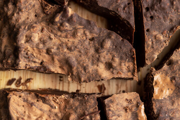 Pieces of chocolate with added cocoa and sugar