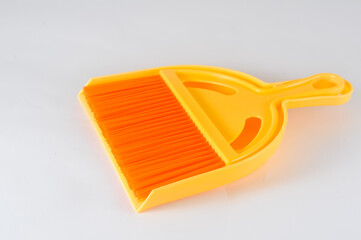 orange plastic broom  isolated on white background