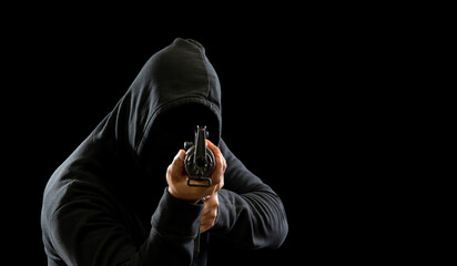 Hacker spy criminal man hands wearing a black shirt, standing on the floor is thief, holding gun,...