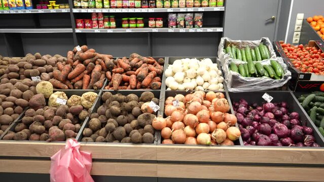 Vegetable counter in organic farm food store. Vegetables in wooden containers on a shop window. Sale of vegetables.