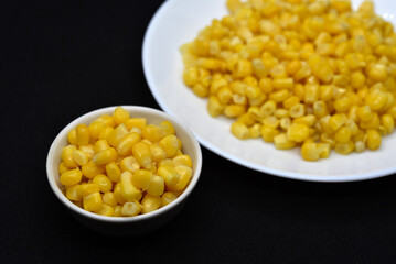 Fresh canned corn on a white plate. Corn salad. Yellow corn kernels.