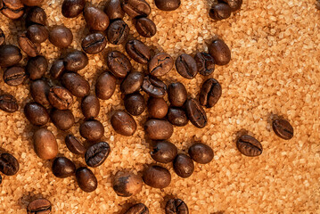 Coffee beans on brown sugar cane, background picture in brown tones