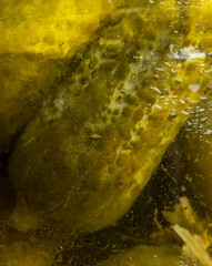 Pickled cucumbers in a glass jar with condensation drops