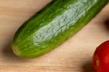 Sliced green long cucumber during salad preparation