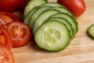 Sliced green long cucumber during salad preparation