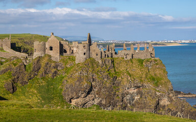 Fototapeta na wymiar Dunluce Castle is a ruined castle on the Causeway Coast and one of the most picturesque and romantic of Irish Castles.