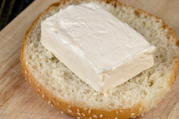 Wheat bun with large pieces of processed cheese inside